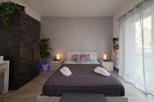 a bedroom with a large bed with two towels on it at Relax room Apartment in Rome