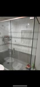 a shower with a glass door in a bathroom at Private 2BD Suite near FAU in Boca Raton