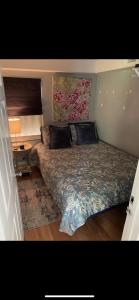 a bedroom with a bed with a floral bedspread at Private 2BD Suite near FAU in Boca Raton