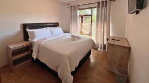 a bedroom with a large bed and a window at Kabana Family Home and Guest House in Cape Town +30 photos