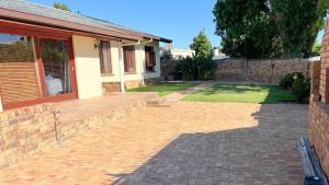 a brick patio in front of a house at Kabana Family Home and Guest House in Cape Town
