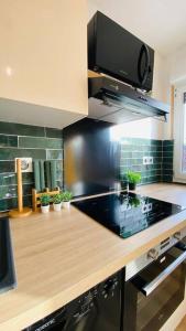 a kitchen with a counter top with a stove top at Appartement standing Le Havre in Le Havre