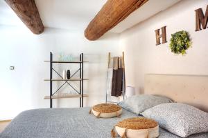 a bedroom with two beds and a shelf at Le Massilia de Steenia in Marseille
