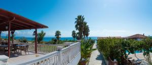 a view of the ocean from the balcony of a resort at Poseidon Beach Hotel in Kastrosikia