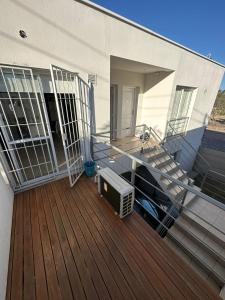 a balcony with a tv and stairs on a house at Departamento Soberania totalmente amoblado in La Cieneguita