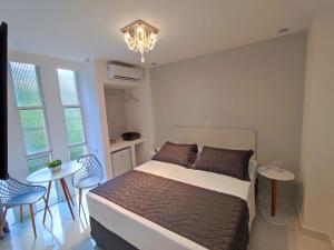 Cama ou camas em um quarto em Grand Hotel Guarujá - A sua Melhor Experiência Beira Mar na Praia!