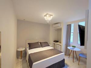 Cama ou camas em um quarto em Grand Hotel Guarujá - A sua Melhor Experiência Beira Mar na Praia!