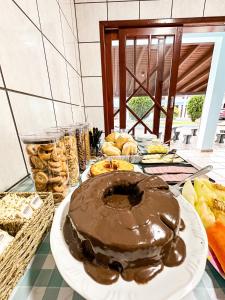 a chocolate cake on a plate on a table at POUSADA SOLAR DE ANITA in Garopaba
