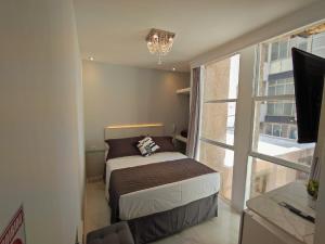 Cama ou camas em um quarto em Grand Hotel Guarujá - A sua Melhor Experiência Beira Mar na Praia!