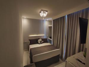 Cama ou camas em um quarto em Grand Hotel Guarujá - A sua Melhor Experiência Beira Mar na Praia!