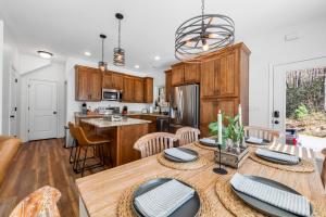 a kitchen with a wooden table and a dining room at Charming Murphy House with Deck & River Views! in Murphy