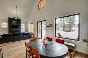 a living room with a table and a couch at Family-Friendly Lead Cabin with Loft and Balcony! in Lead