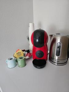 a coffee maker and two cups on a counter at Valpino 