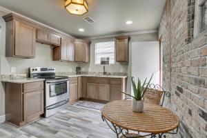 a kitchen with a table and a brick wall at Deck, Yard and Outdoor Dining Destrehan Getaway! in Destrehan