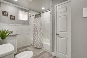 a bathroom with a toilet and a shower at Charming Louisiana Getaway with Deck and Yard! in Destrehan