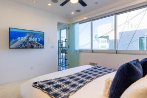 a bedroom with a bed and a large window at Ocean view, two-level condo with stunning view, decks, fast WiFi & fireplace in San Diego