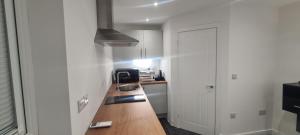 a small kitchen with a counter and a sink at Home away from home! in Yate
