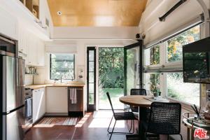 a kitchen and dining room of a tiny house at Drexel Villa in Los Angeles