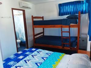 a bedroom with two bunk beds and a mirror at HOSTERIA LA COSTANERA in Salinas