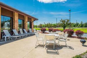 a group of chairs and tables on a patio at Royal Inn Suites in Huntington