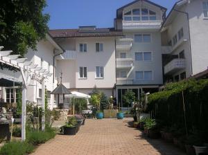 a building with a brick walkway in front of it at Arthotel Ana Panorama in Marktoberdorf