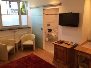 TV a/nebo společenská místnost v ubytování Arthotel Ana Panorama