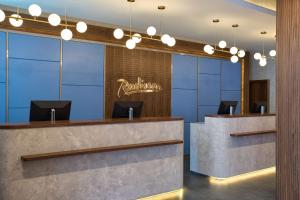 a rendering of a lobby with a reception desk and chandeliers at Radisson Hotel Baku in Baku