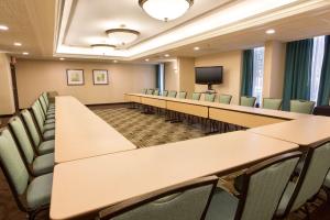 a conference room with tables and chairs and a tv at Drury Inn & Suites St. Louis-Southwest in Peerless Park