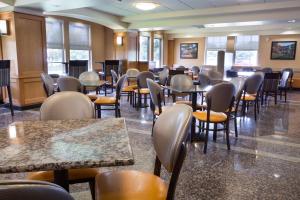 a dining room with tables and chairs and windows at Drury Inn & Suites Lafayette LA in Lafayette +24 photos