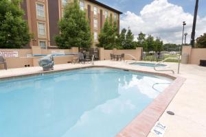 a large blue swimming pool in front of a building at Drury Inn & Suites Lafayette LA in Lafayette