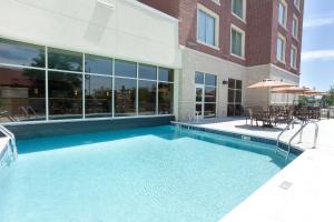 a swimming pool in front of a building at Drury Inn & Suites Grand Rapids in Cascade