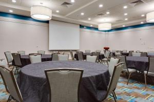 a conference room with a table and chairs and a whiteboard at Drury Plaza Hotel St. Louis St. Charles in St. Charles