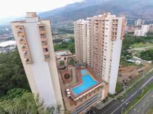 an aerial view of two tall buildings with a swimming pool at Hermoso, moderno y confortable apartamento. in Bello