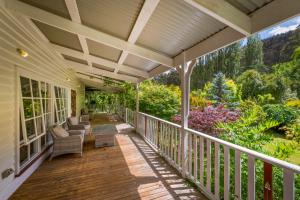 a porch of a house with chairs and trees at Magical Lucindale - Gorgeous 4 Bedroom House in Lucaston