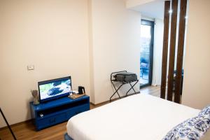 a bedroom with a bed and a tv on a dresser at Terra'Vista Apartments in Tirana