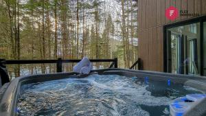a hot tub with an elephant standing in the water at Le Bleu Bourgeois de Portneuf - Natural Elegance - Hot tub, sauna and pool in Pont-Rouge
