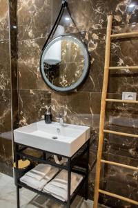 a bathroom with a sink and a mirror at Terra'Vista Apartments in Tirana