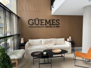 a living room with a white couch and a table at Guemes Hotel & Spa in Salta