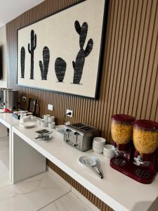 a kitchen with a counter top with a counter sidx sidx sidx at Guemes Hotel & Spa in Salta