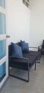 a black couch with blue pillows in a room at Jade Aparts Salinas in Salinas