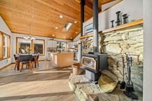 a living room with a stone fireplace in a house at Sand Bucket in Manzanita