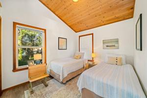 a bedroom with two beds and a window at Sand Bucket in Manzanita