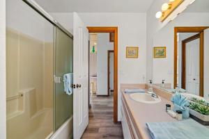 a bathroom with a sink and a mirror at Sand Bucket in Manzanita +38 photos