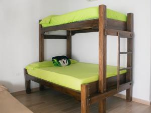 a bunk bed in a room with a green mattress at ZABDI COVEÑAS in Coveñas