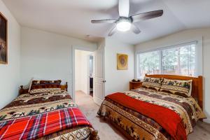 a bedroom with two beds and a ceiling fan at Bear Paw Chateau in Incline Village