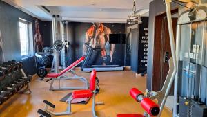 a gym with cardio equipment and a painting of a man at فندق سيتي فيو in Jeddah