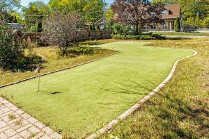 a golf course in the yard of a house at Charming riverside cottage, walk to beach in Wasaga Beach