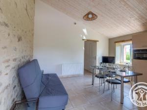 a kitchen and dining room with a table and chairs at Gîte de Charme entre Cholet et Puy du Fou avec Terrasse et Équipements Complets - FR-1-622-33 in Saint-Christophe-du-Bois