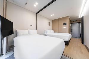 Postel nebo postele na pokoji v ubytování Allzip Archieve4H Residence hotel Busan + 37 fotografií