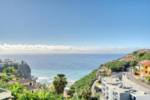 a view of the ocean from a city at Freitas Paradise, a Home in Madeira in Ponta do Sol